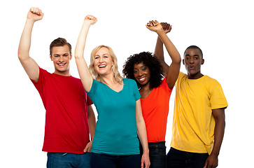 Image showing Excited teenager group posing with raised arms