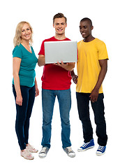 Image showing Full length shot of teenagers with laptop