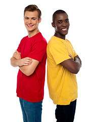 Image showing Friends posing back to back with arms crossed