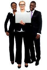 Image showing Group of business people looking into laptop