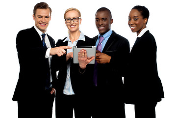 Image showing Business people pointing towards wireless tablet