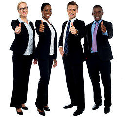 Image showing Corporate team gesturing thumbs up