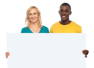 Image showing Attractive couple holding white blank ad board