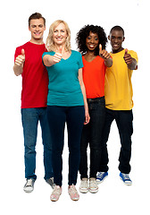 Image showing Happy young teens gesturing thumbs up
