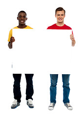 Image showing Trendy young guys presenting blank banner ad