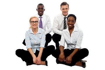 Image showing Four business colleagues sitting on floor