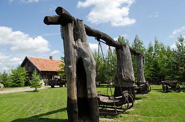 Image showing Retro swing carriage hang on chains on tree trunk 