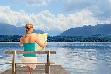 Image showing Woman with map on a lake