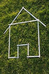 Image showing Shape of a house with rule in green grass