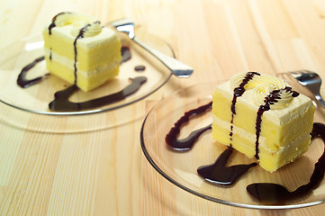 Image showing fresh cream cake closeup with chocolate sauce