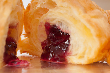 Image showing croissant French brioche filled with berries jam