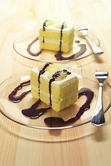 Image showing fresh cream cake closeup with chocolate sauce