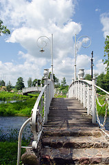 Image showing White decorative bridges through park stream sky 