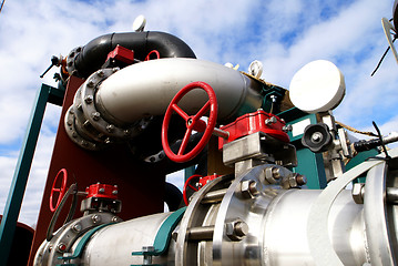 Image showing industrial pipelines and valve with a natural blue background