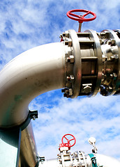 Image showing industrial pipelines and valve with a natural blue background