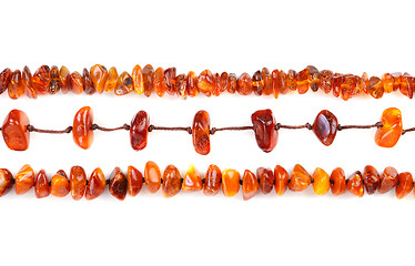 Image showing Beads of amber laid in a row