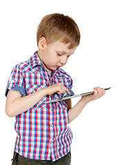 Image showing A boy in a plaid shirt with a tablet computer
