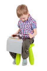 Image showing boy with a Tablet PC sitting on a chair