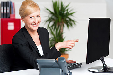 Image showing Businesswoman pointing at computer screen