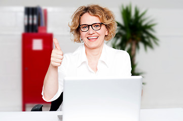 Image showing Successful businesswoman gesturing thumbs up