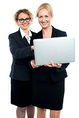 Image showing Cheerful corporate ladies using laptop