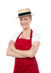 Image showing Confident cheerful female cook wearing hat