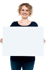 Image showing Casual lady displaying blank white billboard