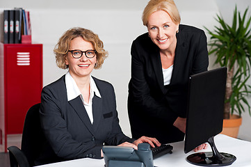 Image showing Woman working in office with colleague