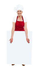 Image showing Beautiful chef showing blank white board