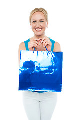 Image showing Happy aged woman carrying shopping bag