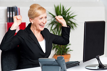 Image showing Excited corporate lady looking at computer screen