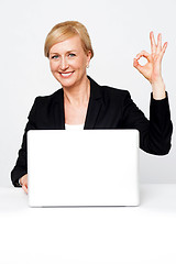 Image showing Happy businesswoman gesturing okay sign