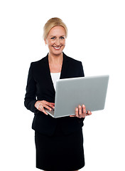 Image showing Corporate woman holding laptop