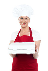 Image showing Female baker presenting pizza to you in a box
