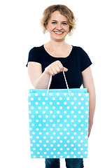 Image showing Shopaholic female holding shopping bag