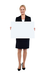 Image showing Businesswoman showing blank white billboard