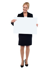 Image showing Female executive pointing towards white ad board