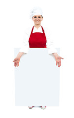 Image showing Female cook showing white blank ad board