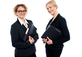 Image showing Happy middle aged business females holding files