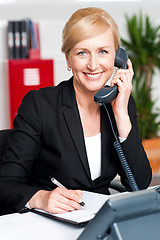 Image showing Corporate lady communicating on phone