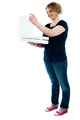 Image showing Beautiful woman looking into pizza box