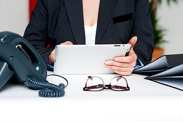 Image showing Cropped image of woman holding tablet device