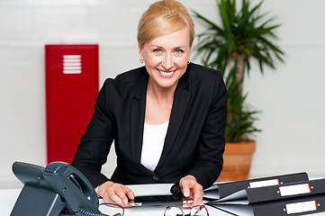 Image showing Smiling corporate lady holding wireless tablet