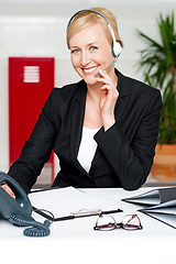 Image showing Customer support staff holding mic and communicating