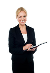 Image showing Corporate woman writing on clipboard