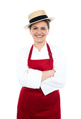 Image showing Lady cook in white red uniform wearing hat