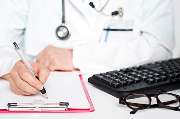 Image showing Closeup shot of female doctor writing prescription