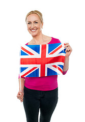 Image showing Cheerful female supporter holding national flag