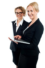 Image showing Two corporate women working on laptop