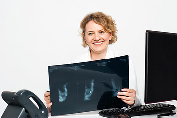 Image showing Experienced female surgeon holding x-ray report